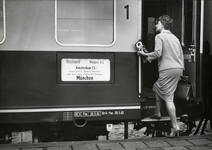 169790 Afbeelding van een vrouw die instapt in de internationale trein Rheingold op het N.S.-station Amsterdam Amstel ...
